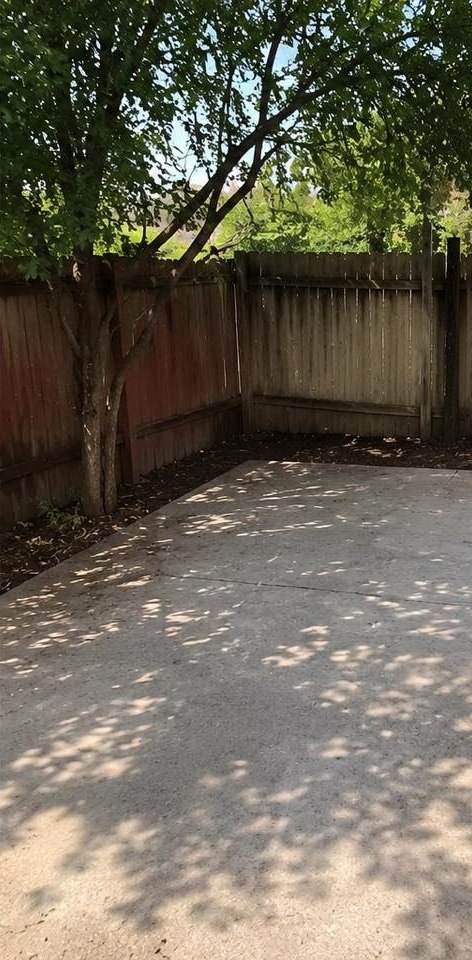 The same patio swept down to clean concrete with the carpet and debris gone