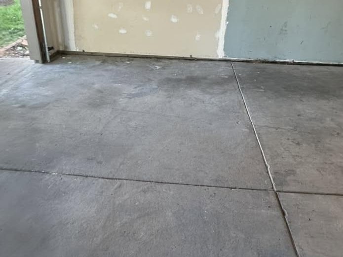 The same garage floor swept clean at the end of the job